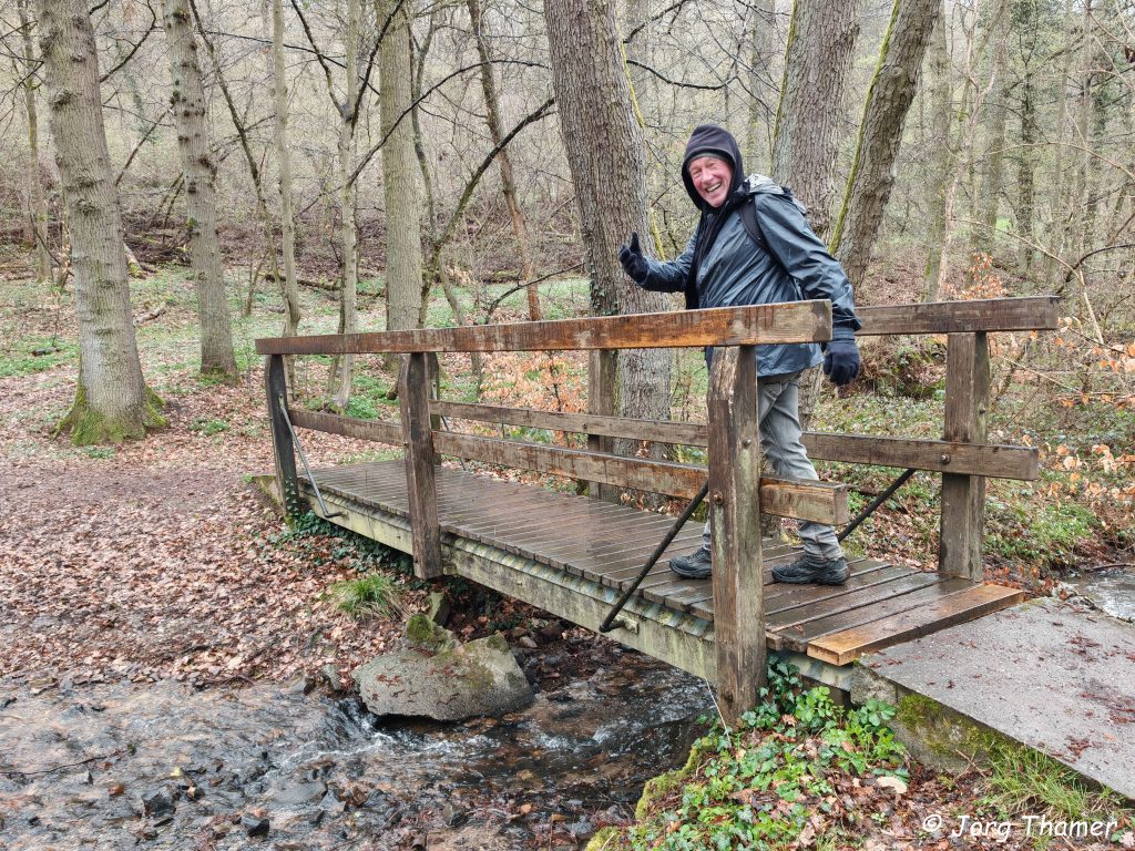 Pilger auf einer Holzbrücke